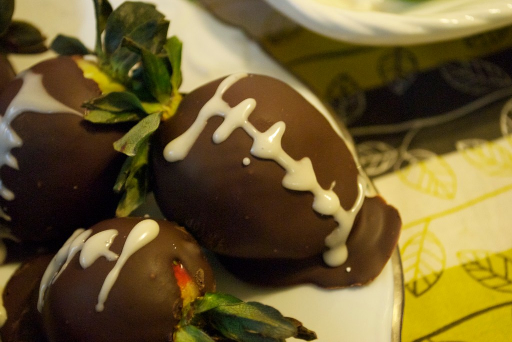 Chocolate dipped strawberry "footballs".